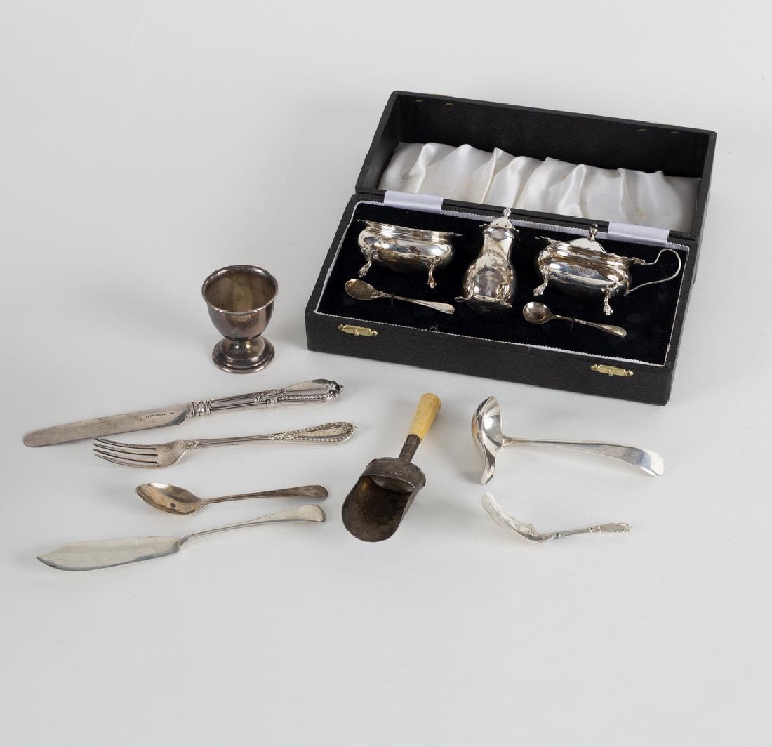 A three-piece silver cruet, Birmingham 1974, in a: A three-piece silver cruet, Birmingham 1974, in a fitted case, an egg cup, caddy spoons, etc., approximately 330gm weighable