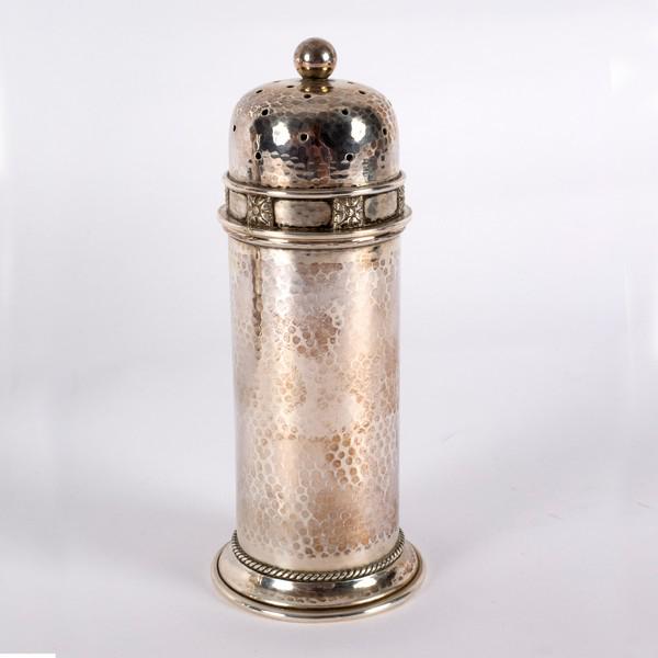 An Arts & Crafts silver caster, AE Jones, Birmingham: An Arts & Crafts silver caster, AE Jones, Birmingham 1928, of pillar box form with hammered finish, 16.5cm high