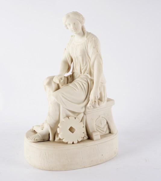 A parian figure of a seated woman with a millstone at: A parian figure of a seated woman with a millstone at her side, on an oval base, 32cm high