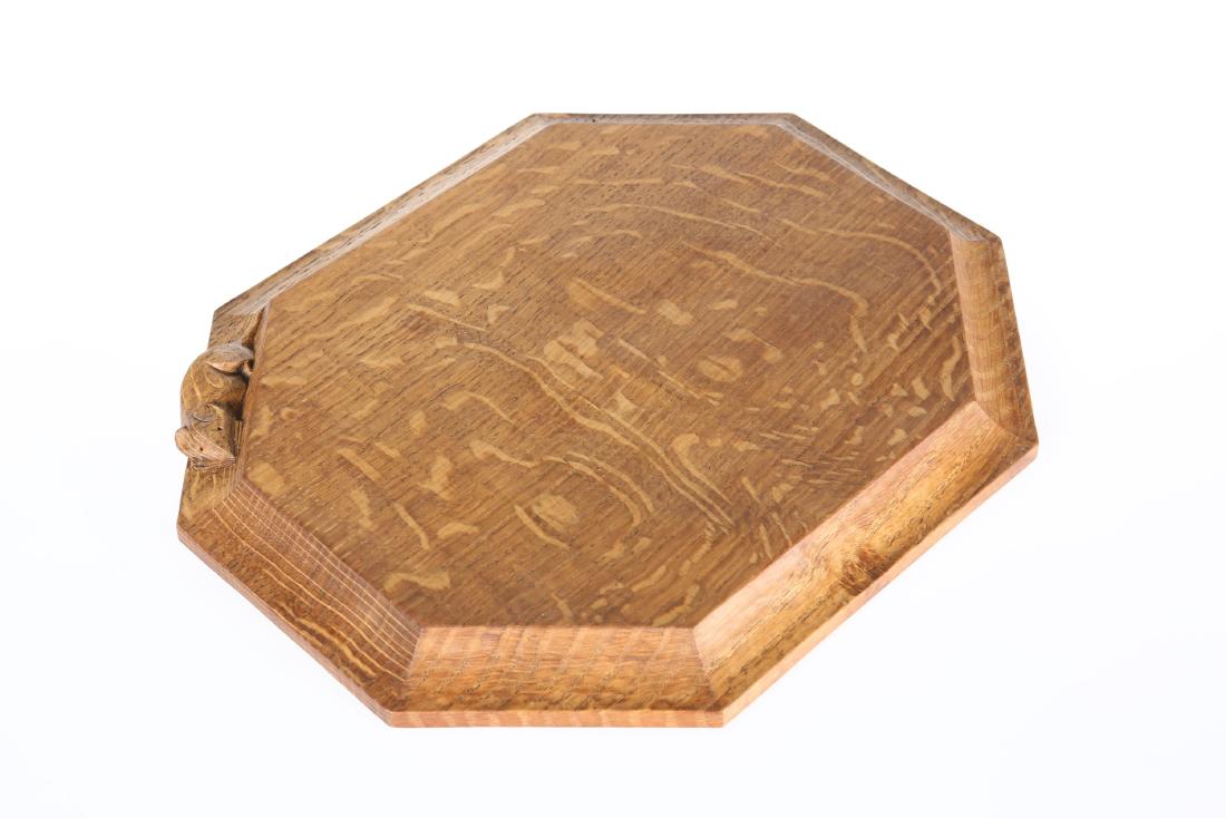 ROBERT THOMPSON OF KILBURN A MOUSEMAN TIGER STRIPE OAK: ROBERT THOMPSON OF KILBURN A MOUSEMAN TIGER STRIPE OAK BREADBOARD, of rectangular form with canted corners, the oak with a lovely grain, adzed, carved mouse signature. 30.5cm by 25.5cm