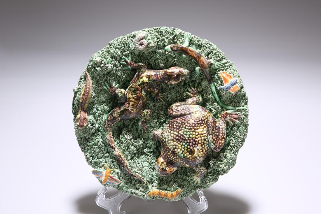 A 19TH CENTURY PALISSY STYLE DISH, JOSE A. CUNHA,: A 19TH CENTURY PALISSY STYLE DISH, JOSE A. CUNHA, PORTUGAL, applied with lizards, toad and insects against a typical shredded ground, impressed factory mark. Diameter 24.5cm
