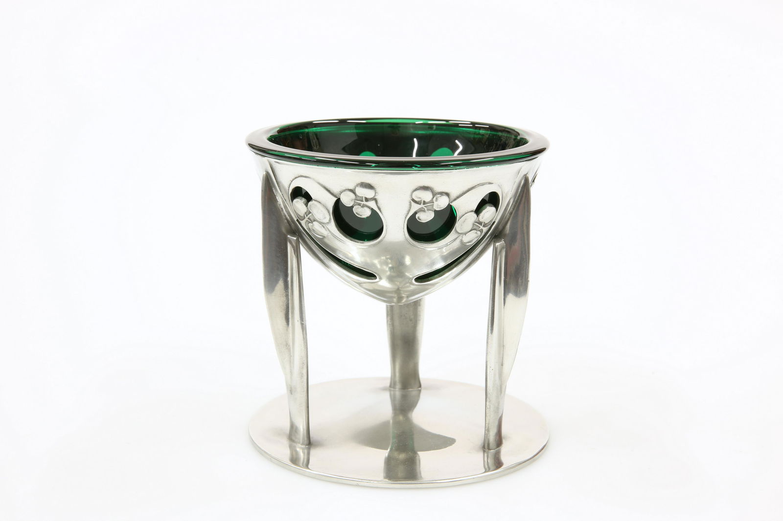 A LIBERTY & CO TUDRIC PEWTER COUPE, DESIGNED BY: A LIBERTY & CO TUDRIC PEWTER COUPE, DESIGNED BY ARCHIBALD KNOX,Â no. 0276, the bowl cast and pierced with stylised foliage, raised on three finned supports issuing from a slightly domed base, stampe