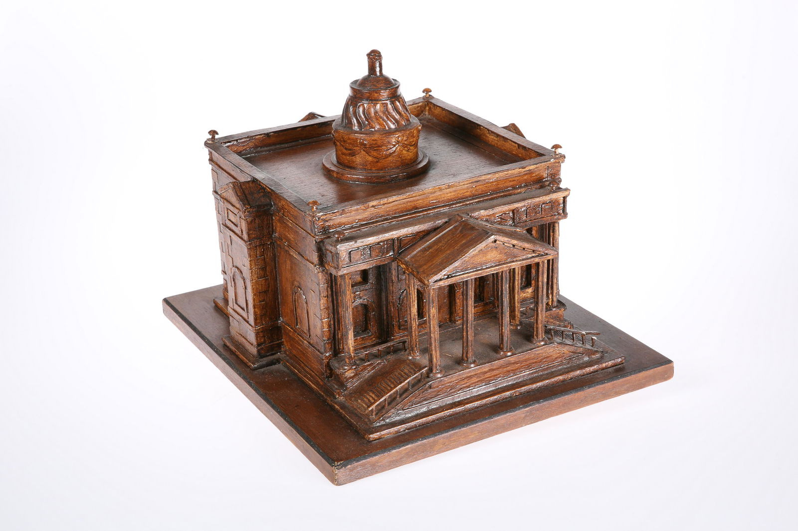 A CARVED WOODEN ARCHITECTURAL MODEL OF A RENAISSANCE: A CARVED WOODEN ARCHITECTURAL MODEL OF A RENAISSANCE CHURCH, stained, on a wooden base. 28.5cm by 32cm by 36cm
