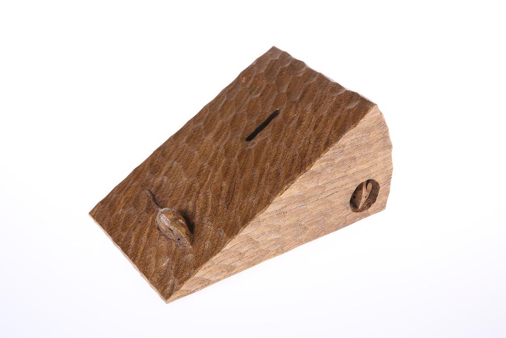 ROBERT THOMPSON OF KILBURN A MOUSEMAN OAK MONEYBOX,: ROBERT THOMPSON OF KILBURN A MOUSEMAN OAK MONEYBOX, WITH RARE FEATURE OF TWO MICE, carved as a wedge of cheese with heavily tooled surface, signed with two mice. 20cm wide, 13cm deep