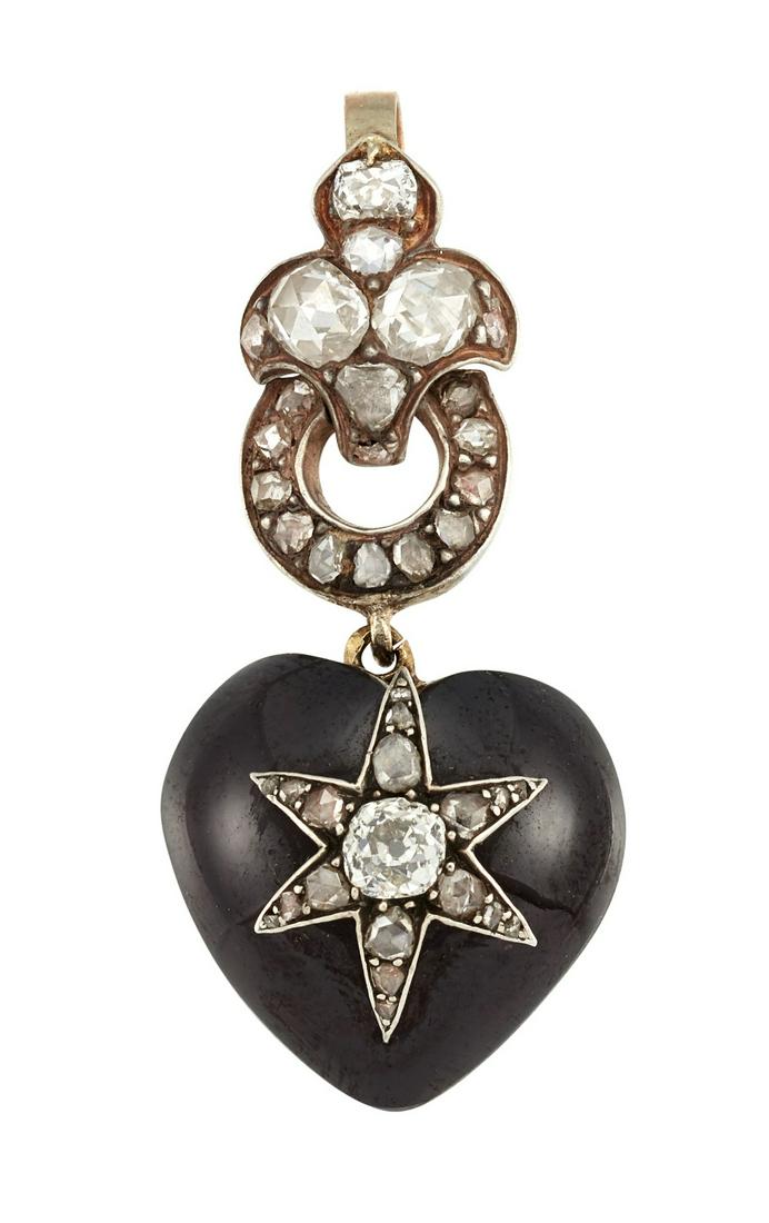 A GARNET AND DIAMOND PENDANT The heart-shaped cabochon: A GARNET AND DIAMOND PENDANT The heart-shaped cabochon garnet with glass locket to the reverse, centred by a six-rayed star of old brilliant and rose-cut diamonds, to a rose-cut diamond-set surmount,�