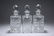 THREE LARGE SQUARE-SECTION GLASS DECANTERS. 26.5cm high