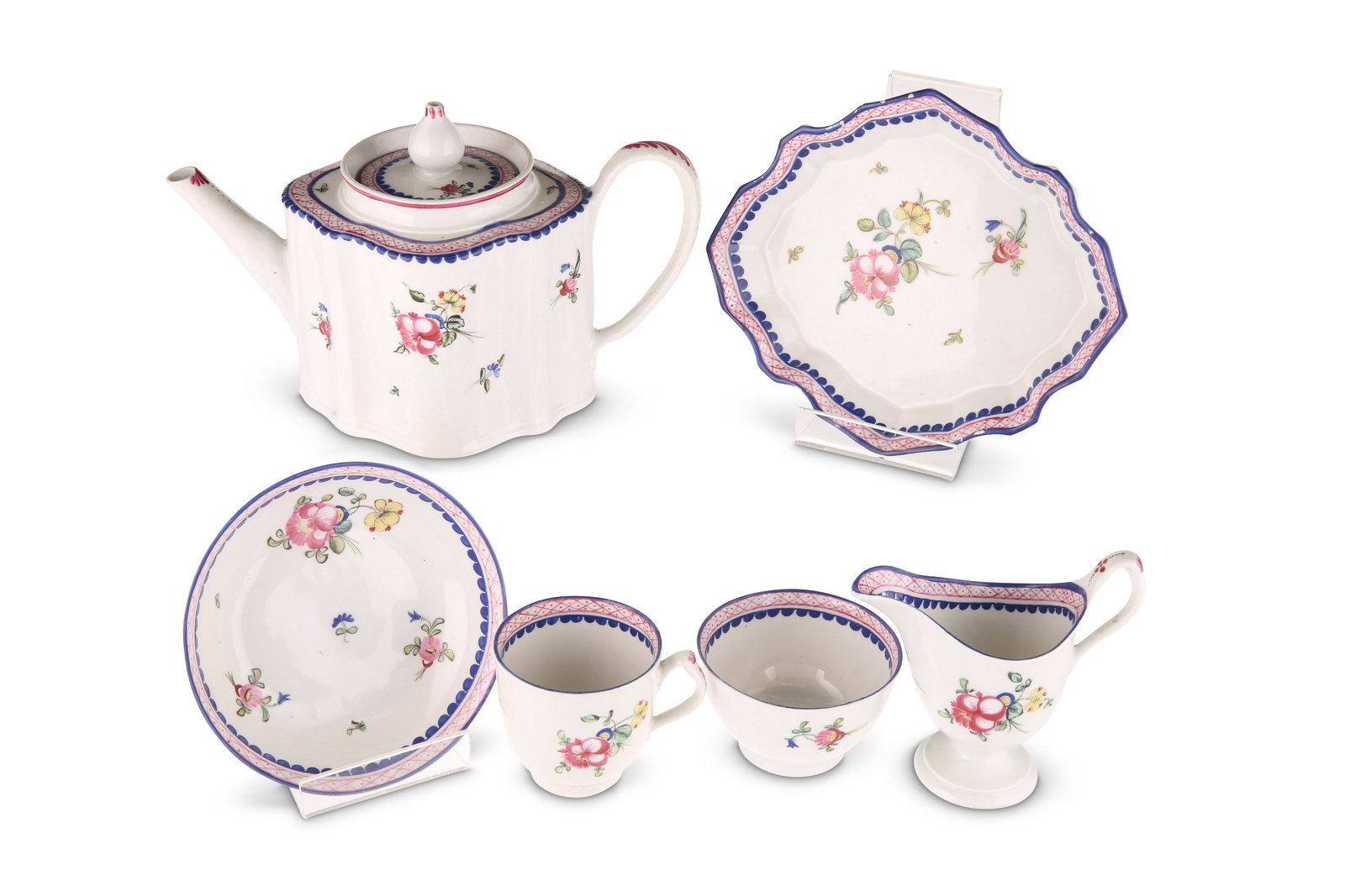 A NEW HALL TEAPOT, CIRCA 1782-1785 Silver-shaped with: A NEW HALL TEAPOT, CIRCA 1782-1785 Silver-shaped with rosette feet and acanthus leaf moulding to underside of spout, painted to pattern number 22 with floral sprays within puce-hatched blue borders; t