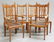 A SET OF SIX ARTS AND CRAFTS OAK DINING CHAIRS,