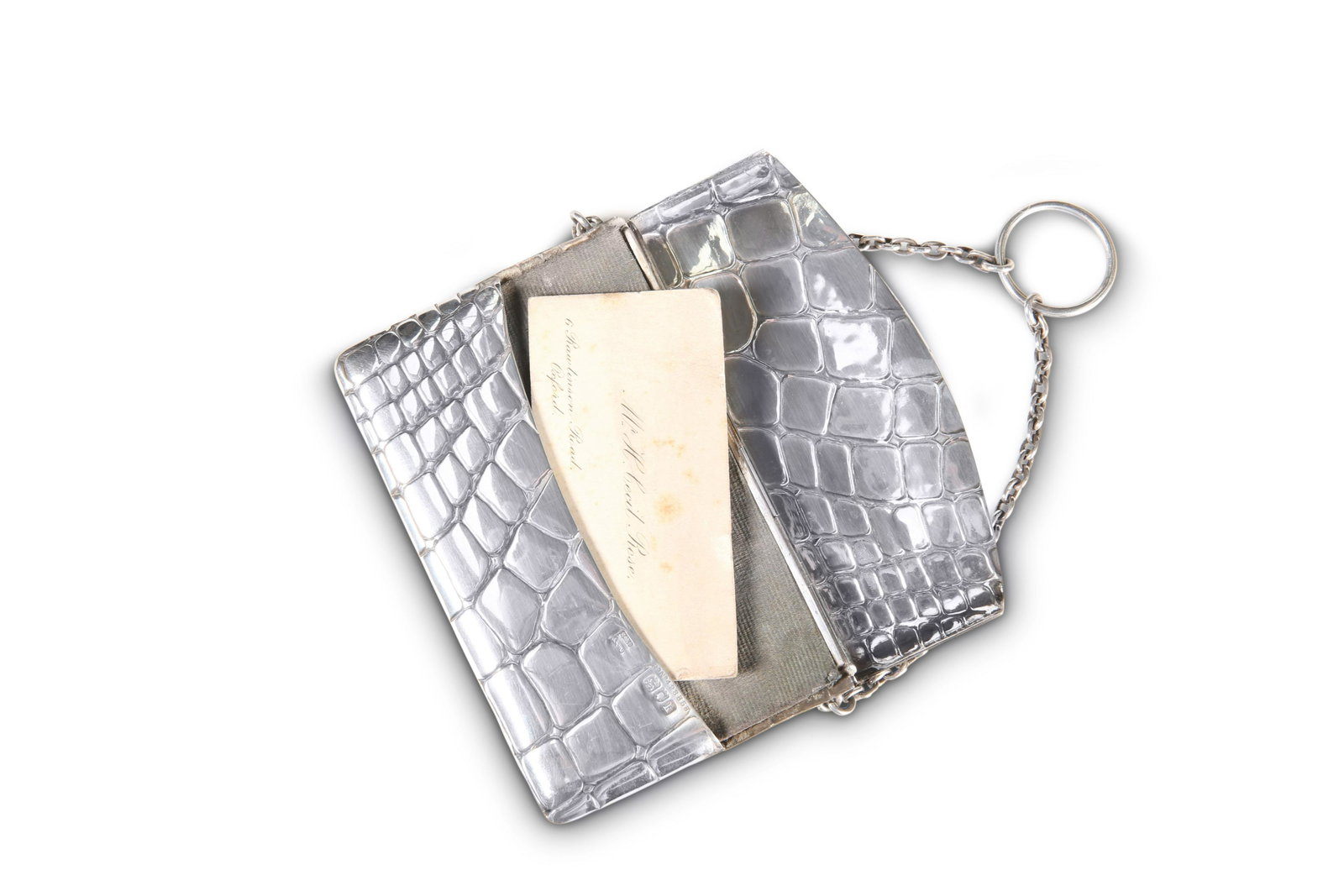 AN EDWARDIAN SILVER CARD CASE, by Sampson Mordan & Co,: AN EDWARDIAN SILVER CARD CASE, by Sampson Mordan & Co, London 1905, in the form of a crocodile handbag with hinged cover, chain and suspension loop. 10.5cm long, 7cm high, gross 2.9 troy ounces