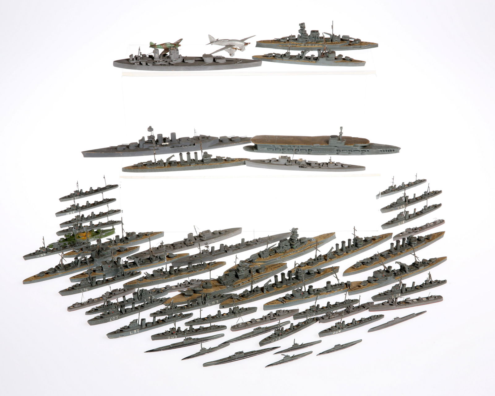 A COLLECTION OF SHIP MODELS, including wooden examples: A COLLECTION OF SHIP MODELS, including wooden examples with Bassett-Lowke labels and metal examples with TM Trade Mark.