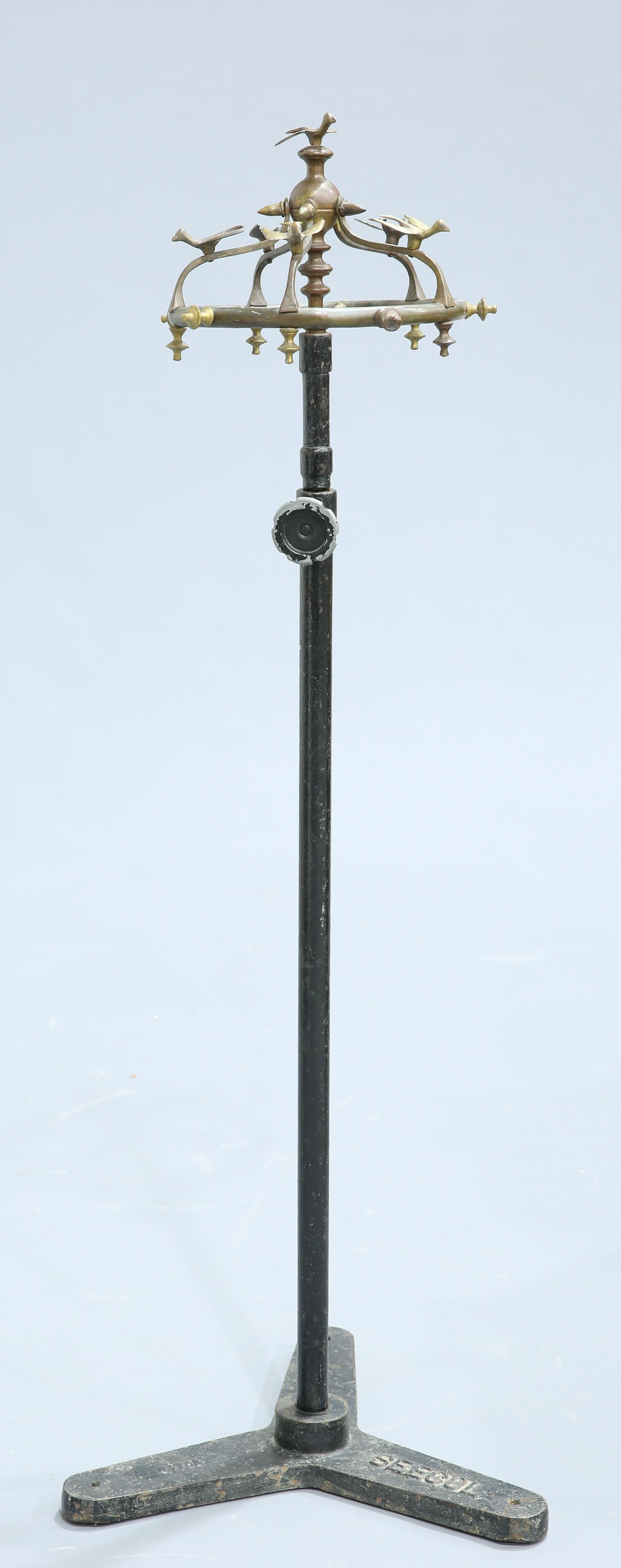 AN UNUSUAL CAST IRON AND BRONZE COAT STAND, EARLY 20TH: AN UNUSUAL CAST IRON AND BRONZE COAT STAND, EARLY 20TH CENTURY, the bronze domed superstructure applied with birds, on an adjustable cast iron base, signed 'SEECOL'. Max. height 223cm