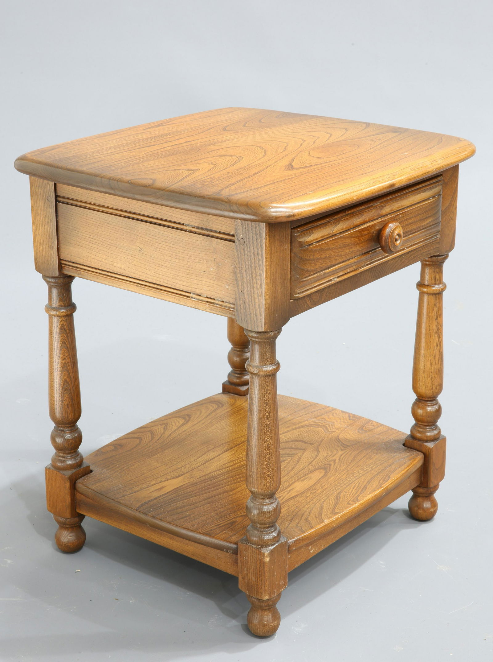 AN ERCOL GOLDEN DAWN SIDE TABLE fitted with a drawer.: AN ERCOL GOLDEN DAWN SIDE TABLE fitted with a drawer. 47.5cm wide