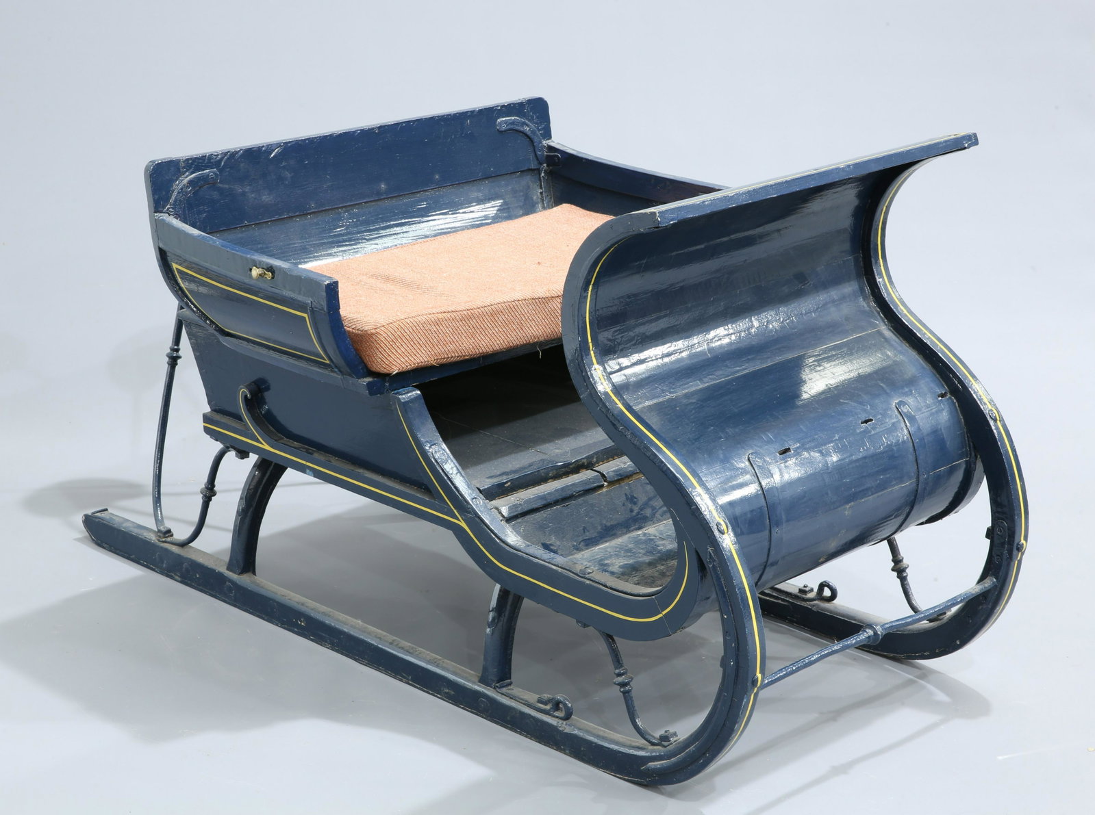 A 19TH CENTURY PAINTED WOODEN AND IRON SLEIGH, probably: A 19TH CENTURY PAINTED WOODEN AND IRON SLEIGH, probably Russian, with removable seat and s-scroll shaped front. 175cm long, 92cm high, 93cm wide