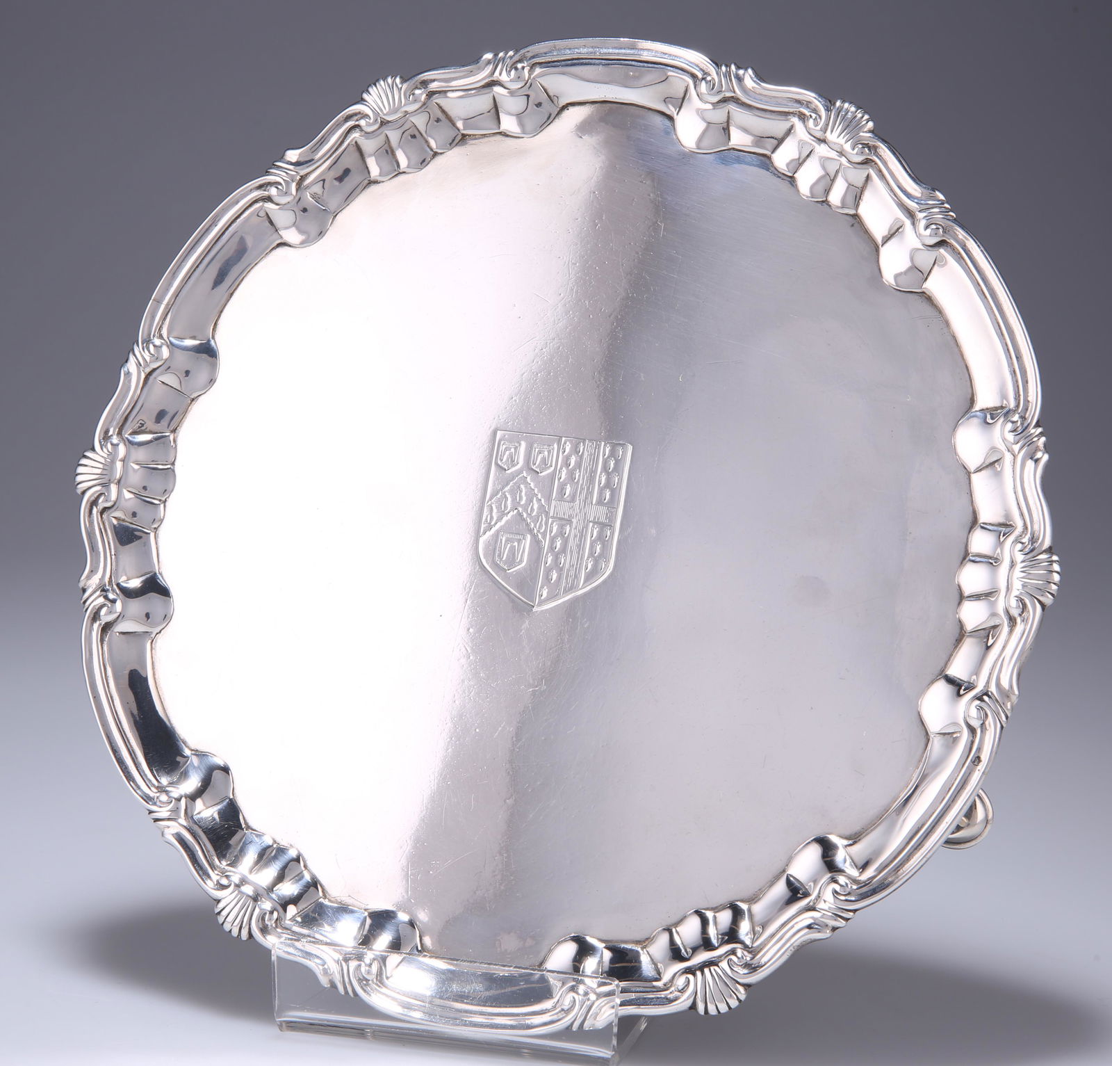 A GEORGE II SILVER SALVER, by William & Robert Peaston,: A GEORGE II SILVER SALVER, by William & Robert Peaston, London 1757, with C-scroll and shell form rim, raised on hoof feet, engraved to centre with armorial. 20.6cm diameter, 12.1 troy ounces