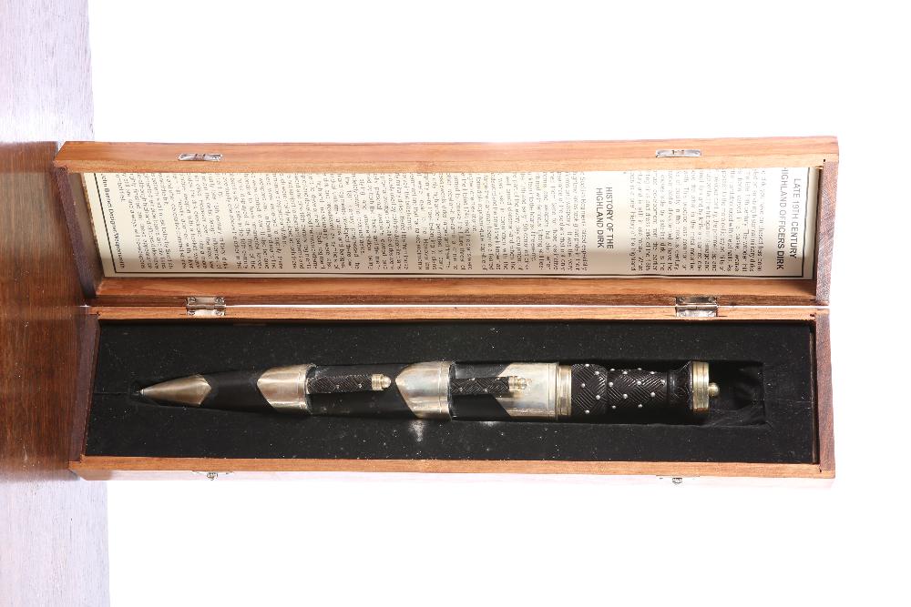 A COPY OF A LATE 19TH CENTURY HIGHLAND OFFICERS': A COPY OF A LATE 19TH CENTURY HIGHLAND OFFICERS' PATTERN DIRK complete with scabbard and smaller knife and fork, the whole contained in its own fitted wooden presentation case.