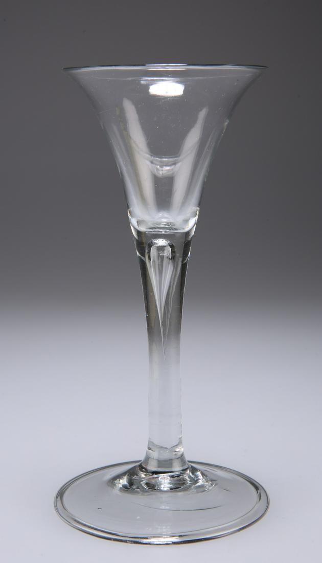 A WINE GLASS, CIRCA 1740, of drawn trumpet form with: A WINE GLASS, CIRCA 1740, of drawn trumpet form with single tear and folded foot. 16cm high