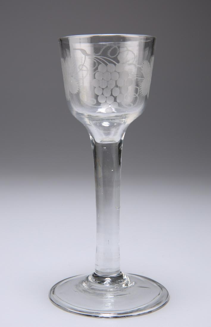 A WINE GLASS, CIRCA 1750, the ogee bowl etched with: A WINE GLASS, CIRCA 1750, the ogee bowl etched with bird in flight and fruiting vine, raised on a plain stem issuing from a folded foot. 14cm high