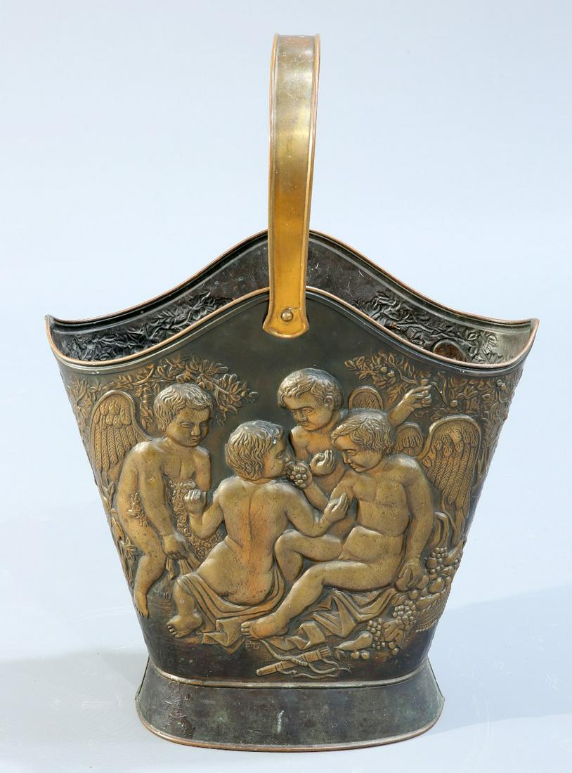 A CONTINENTAL COPPER SWING HANDLE HOD BUCKET, repousse: A CONTINENTAL COPPER SWING HANDLE HOD BUCKET, repousse in high relief with winged putti harvesting and eating grapes, bears stamped initials. 52cm high excluding handle