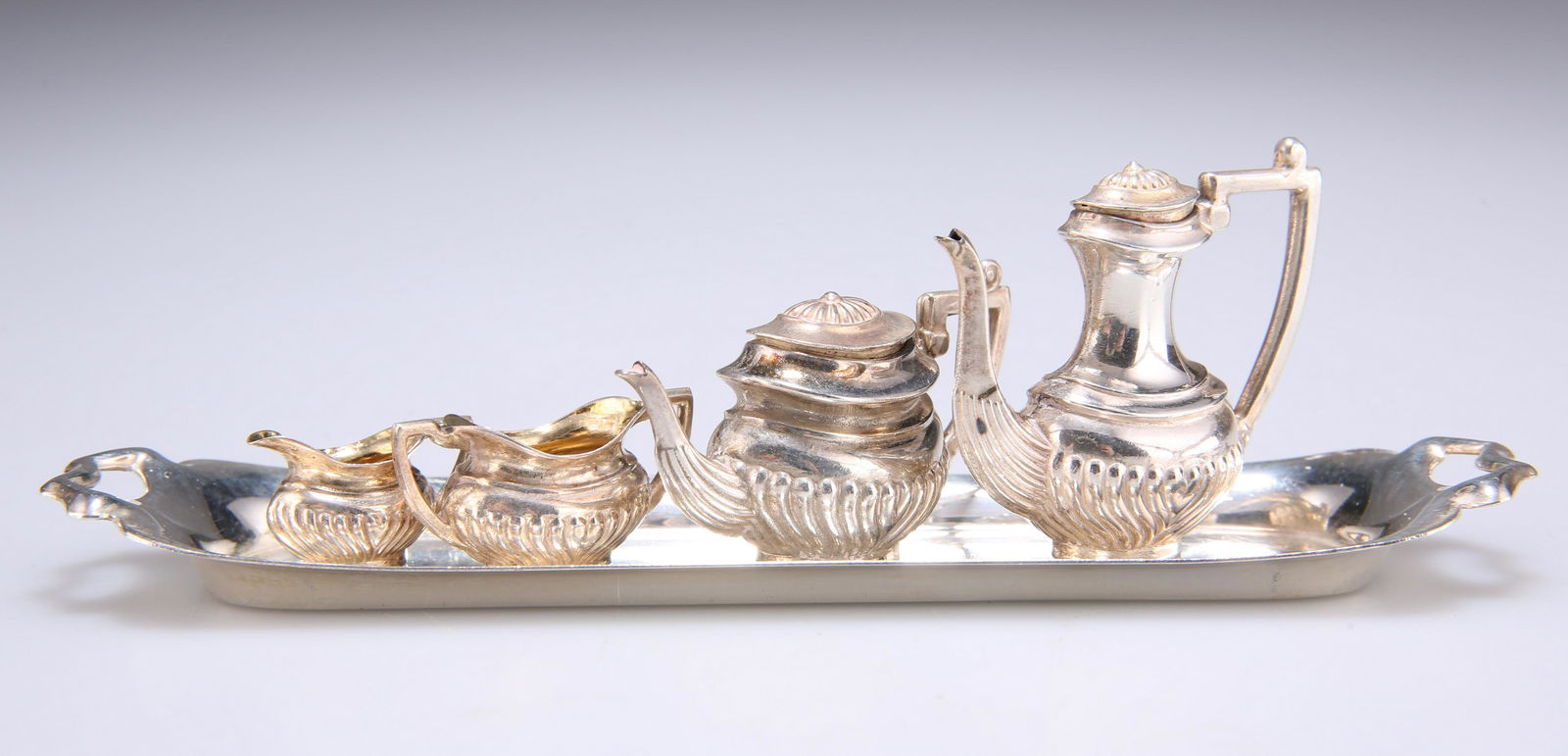 AN ELIZABETH II SILVER MINIATURE TEA AND COFFEE (1 of 2)