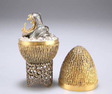 AN ELIZABETH II SILVER-GILT LIMITED EDITION SURPRISE: AN ELIZABETH II SILVER-GILT LIMITED EDITION SURPRISE EGG, by Stuart Devlin, London 1973, no. 12, ovoid form with textured decoration, the egg opens to reveal a roaring hippopotamus head, on a filigre