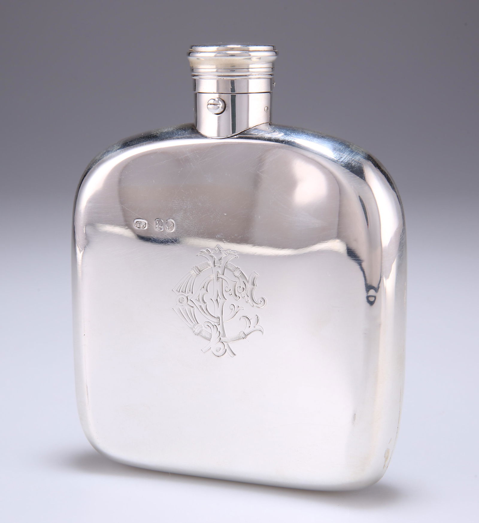 A VICTORIAN SILVER HIP FLASK, by Thomas Johnson: A VICTORIAN SILVER HIP FLASK, by Thomas Johnson I, London 1870, rounded square form, shaped for the pocket, push-button sprung cap, engraved to the front with Cunningham Clan crest above their motto