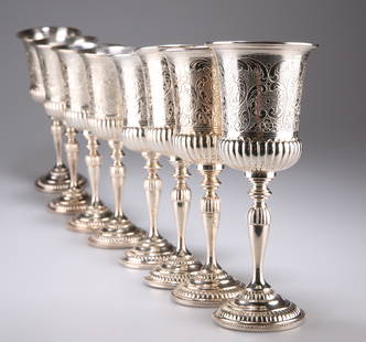 A SET OF EIGHT SILVER-PLATED GOBLETS, each campana bowl: A SET OF EIGHT SILVER-PLATED GOBLETS, each campana bowl partially reeded and flat chased with C-scrolls and flowerheads, raised on a knopped baluster stem issuing from a domed foot. 18.5cm