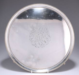 AN OLD SHEFFIELD PLATE SALVER, CIRCA 1790, circular: AN OLD SHEFFIELD PLATE SALVER, CIRCA 1790, circular with beaded borders and shell-cast scroll feet, engraved with a monogram. 36.5cm diameter