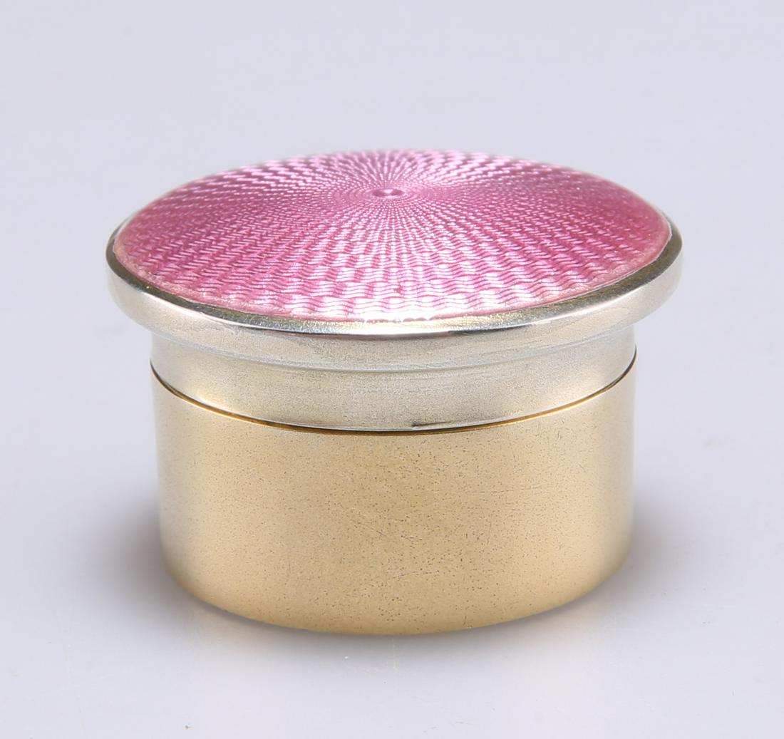 A GEORGE V SILVER-GILT AND ENAMEL BOX, the base by : A GEORGE V SILVER-GILT AND ENAMEL BOX, the base by Richard Comyns, London 1927, the cover of the same date but different maker, with pink guilloche enamel and glass liner. 3.5cm diameter