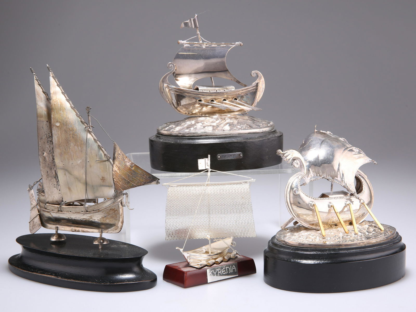 TWO FOREIGN SILVER MODELS OF SHIPS, stamped 800 and 925: TWO FOREIGN SILVER MODELS OF SHIPS, stamped 800 and 925 respectively; together with TWO UNMARKED SHIP MODELS. (4) Tallest 15.5cm including plinth