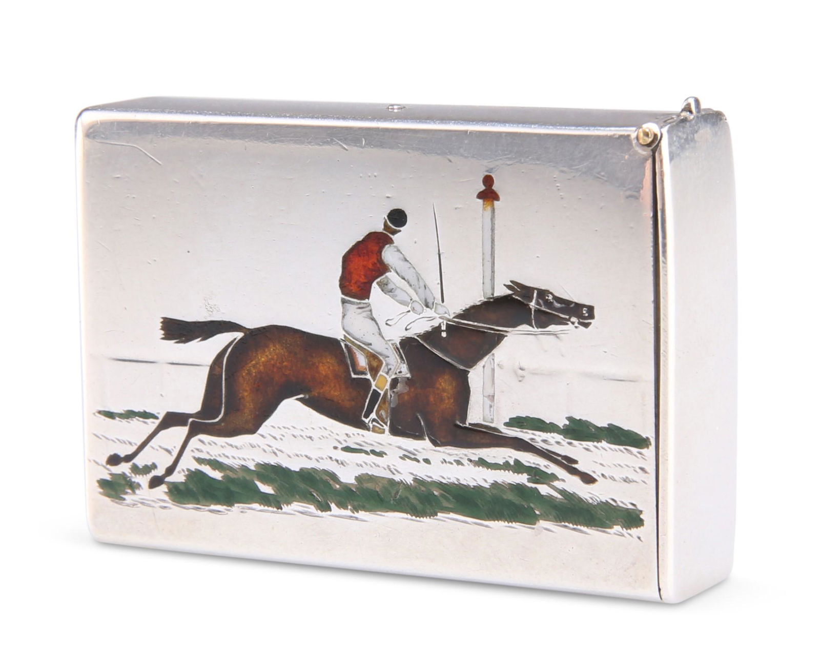 A VICTORIAN SILVER AND ENAMEL VESTA CASE, by Thomas: A VICTORIAN SILVER AND ENAMEL VESTA CASE, by Thomas Johnson II, London 1886, rectangular, the front engraved and enamelled with a jockey crossing the finishing line, the reverse engraved with a mono