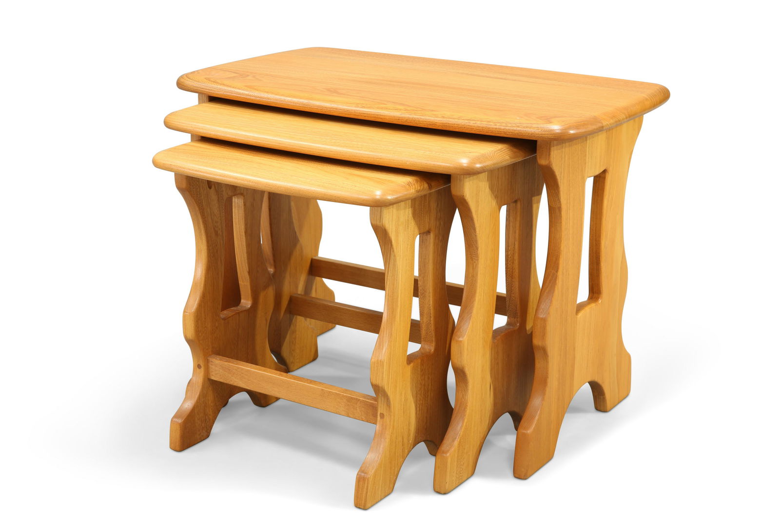 A NEST OF THREE ERCOL TABLES, with trestle ends. (3): A NEST OF THREE ERCOL TABLES, with trestle ends. (3) Largest 42cm high, 56.5cm wide, 35cm deep