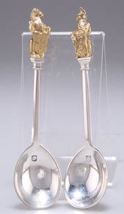 A PAIR OF ELIZABETH II SILVER AND PARCEL-GILT SPOONS,: A PAIR OF ELIZABETH II SILVER AND PARCEL-GILT SPOONS, by Richard Comyns, London 1973, each with heraldic terminal. (2) 11.5cm, 2.1 troy ounces