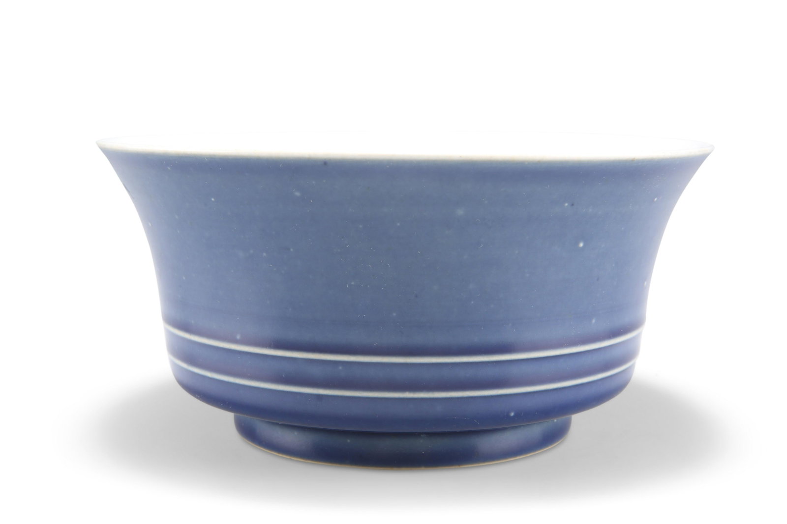 A CHINESE MONOCHROME BOWL, circular with twin reeded: A CHINESE MONOCHROME BOWL, circular with twin reeded bands, blue glaze, bears six character mark within concentric circles. 18cm diameter