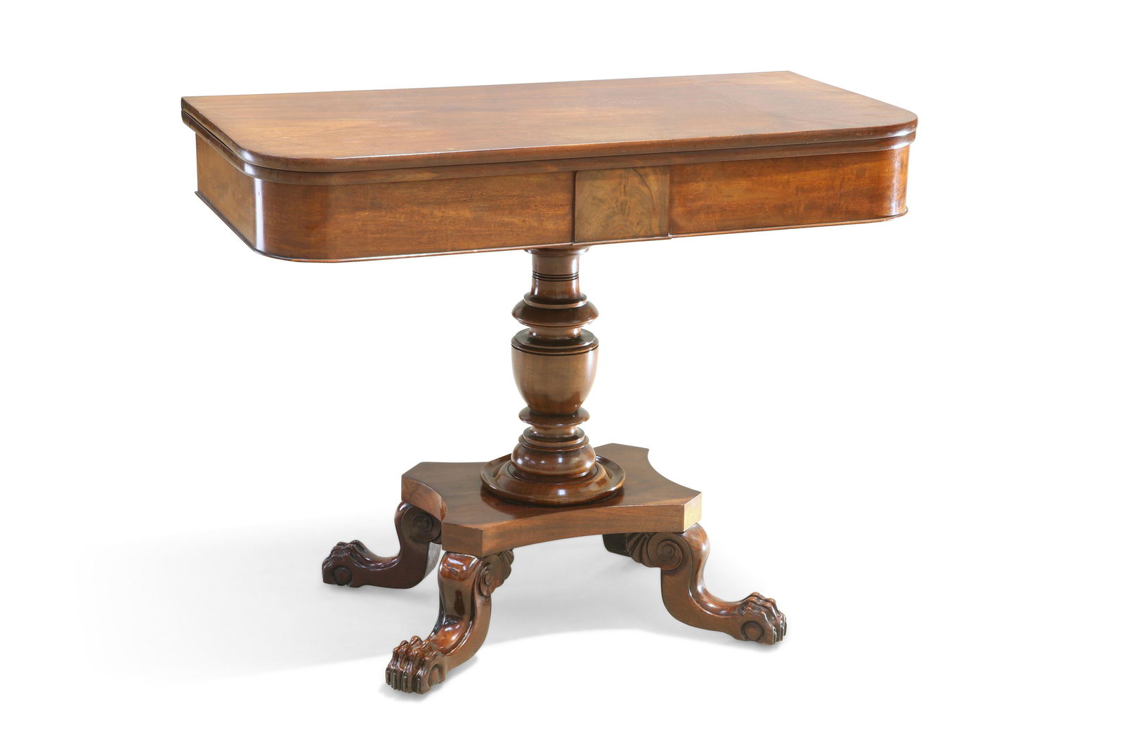 A REGENCY MAHOGANY FOLDOVER TEA TABLE, the rectangular: A REGENCY MAHOGANY FOLDOVER TEA TABLE, the rectangular top with rounded corners, above a plain frieze, raised on a turned vasi-form stem issuing from a quad-form platform base, raised on boldly scroll