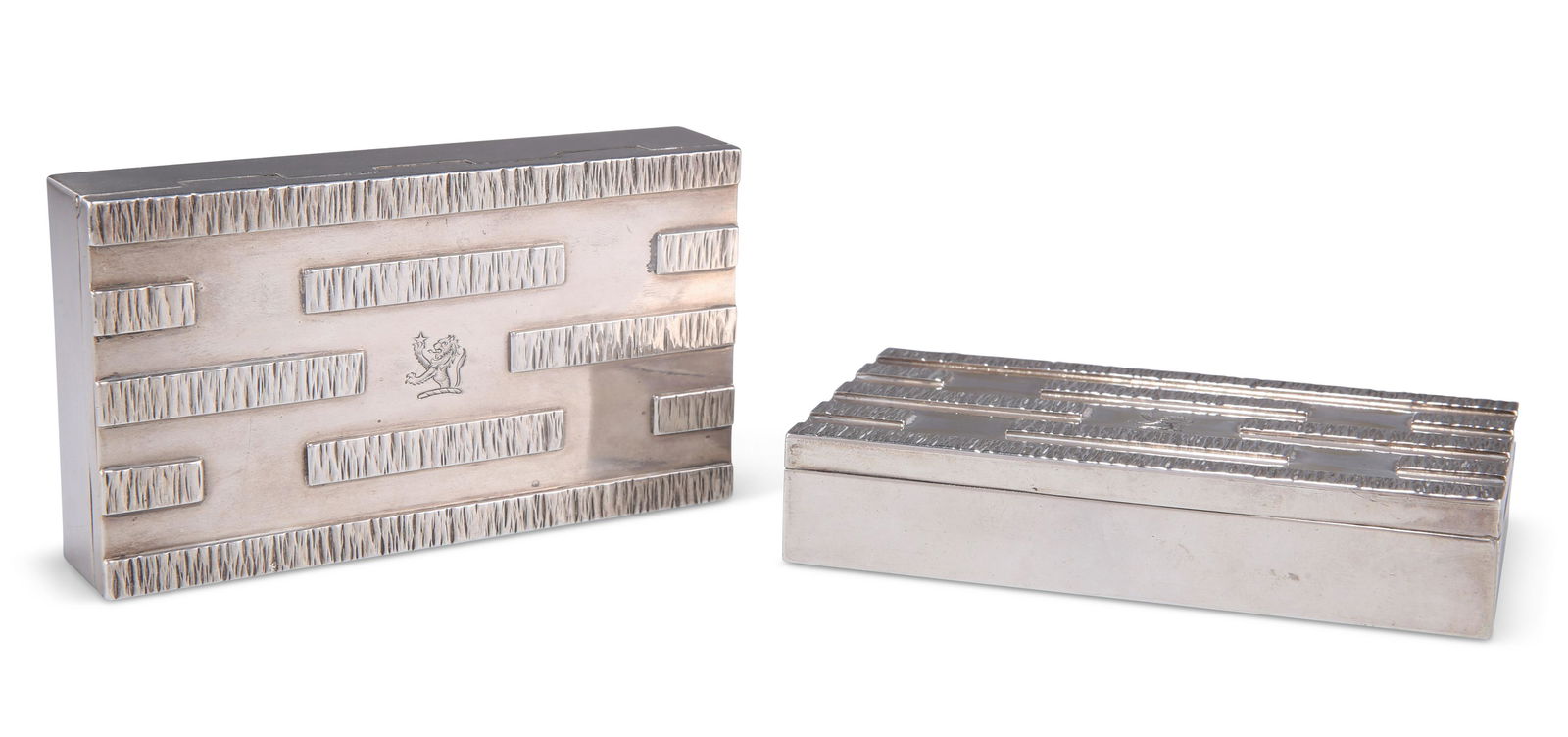 A PAIR OF ELIZABETH II SILVER CIGARETTE BOXES, by Gerald Be: A PAIR OF ELIZABETH II SILVER CIGARETTE BOXES, by Gerald Benney (1930-2008), London 1964, rectangular, each hinged lid with bark-effect raised strips and engraved with a crest. (2) 12.5cm wide, 7cm de