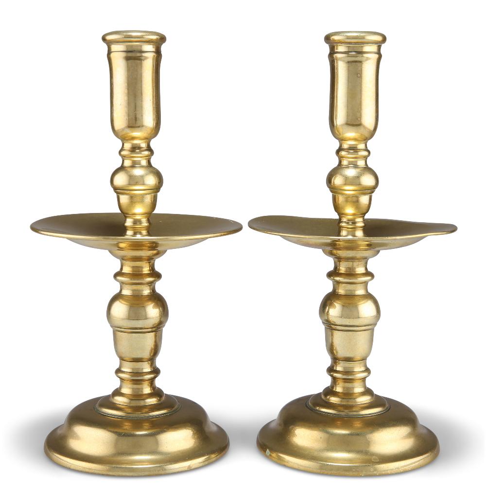 A LARGE PAIR OF HEEMSKIRK BRASS CANDLESTICKS, with baluster stems and dished drip pans. (2) 24cm hig (1 of 1)