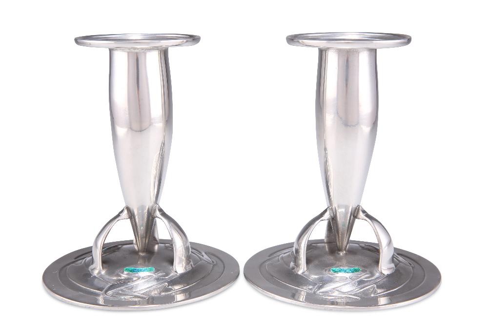 ARCHIBALD KNOX FOR LIBERTY & CO, A PAIR OF TUDRIC PEWTER AND ENAMEL CANDLESTICKS, nos. 0221, each to (1 of 1)