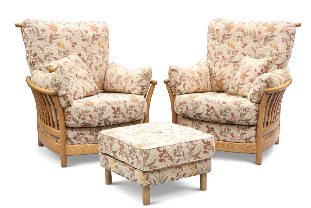 A PAIR OF ERCOL 'RENAISSANCE' LIGHT ELM LOUNGE CHAIRS AND FOOTSTOOL, with floral patterned upholster: A PAIR OF ERCOL 'RENAISSANCE' LIGHT ELM LOUNGE CHAIRS AND FOOTSTOOL, with floral patterned upholstery and loose cushions. (3) Height of backs of chairs 97cm