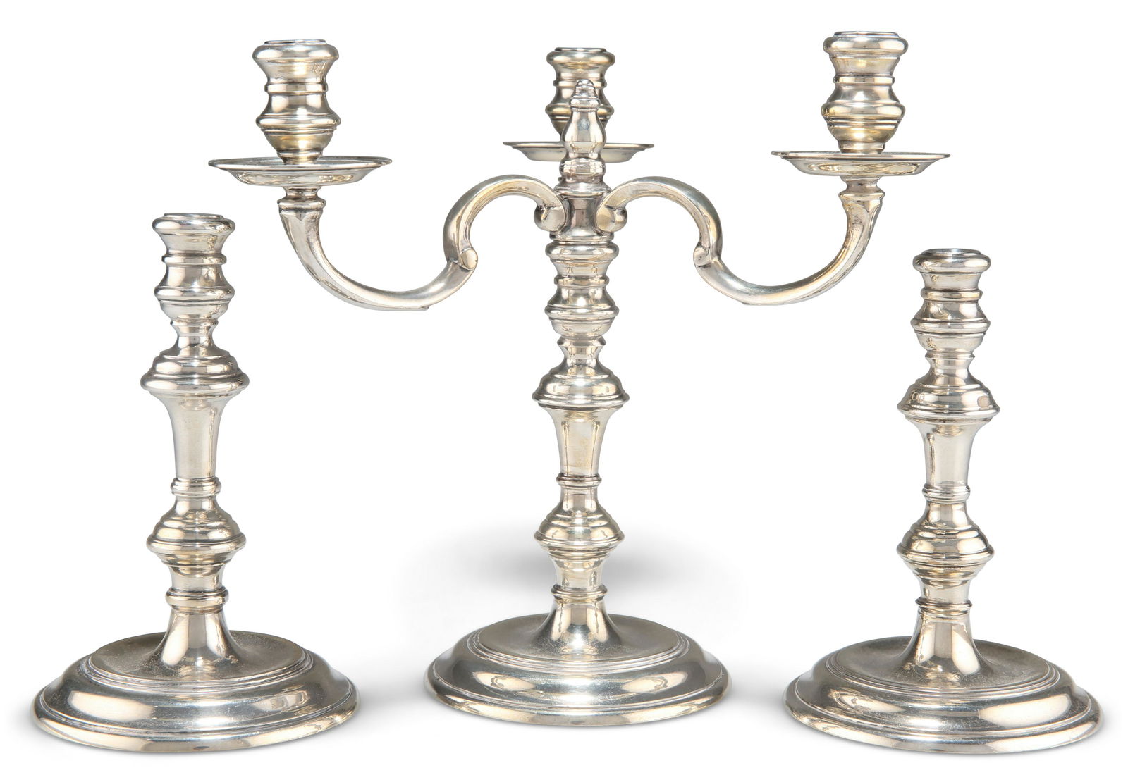 AN ELIZABETH II SILVER MINIATURE CANDELABRA AND A PAIR OF CANDLESTICKS, by Richard Comyns, retailed: AN ELIZABETH II SILVER MINIATURE CANDELABRA AND A PAIR OF CANDLESTICKS, by Richard Comyns, retailed by Dunhill, in 18th Century style, the three-light candelabra London 1961, the pair of candlesticks