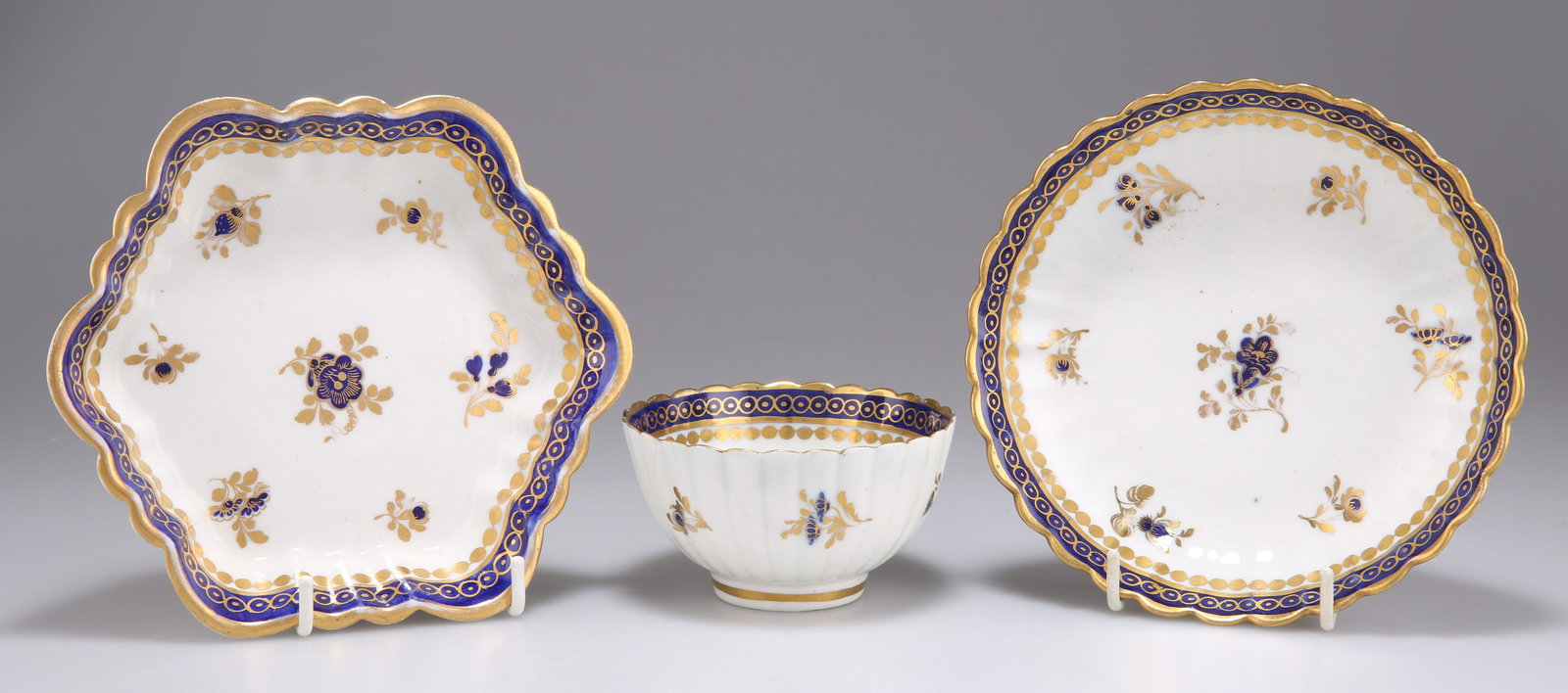 A CAUGHLEY 'DRESDEN FLOWERS' TEA BOWL, SAUCER AND HEXAGONAL STAND, CIRCA 1780-1785, of fluted form, (1 of 1)