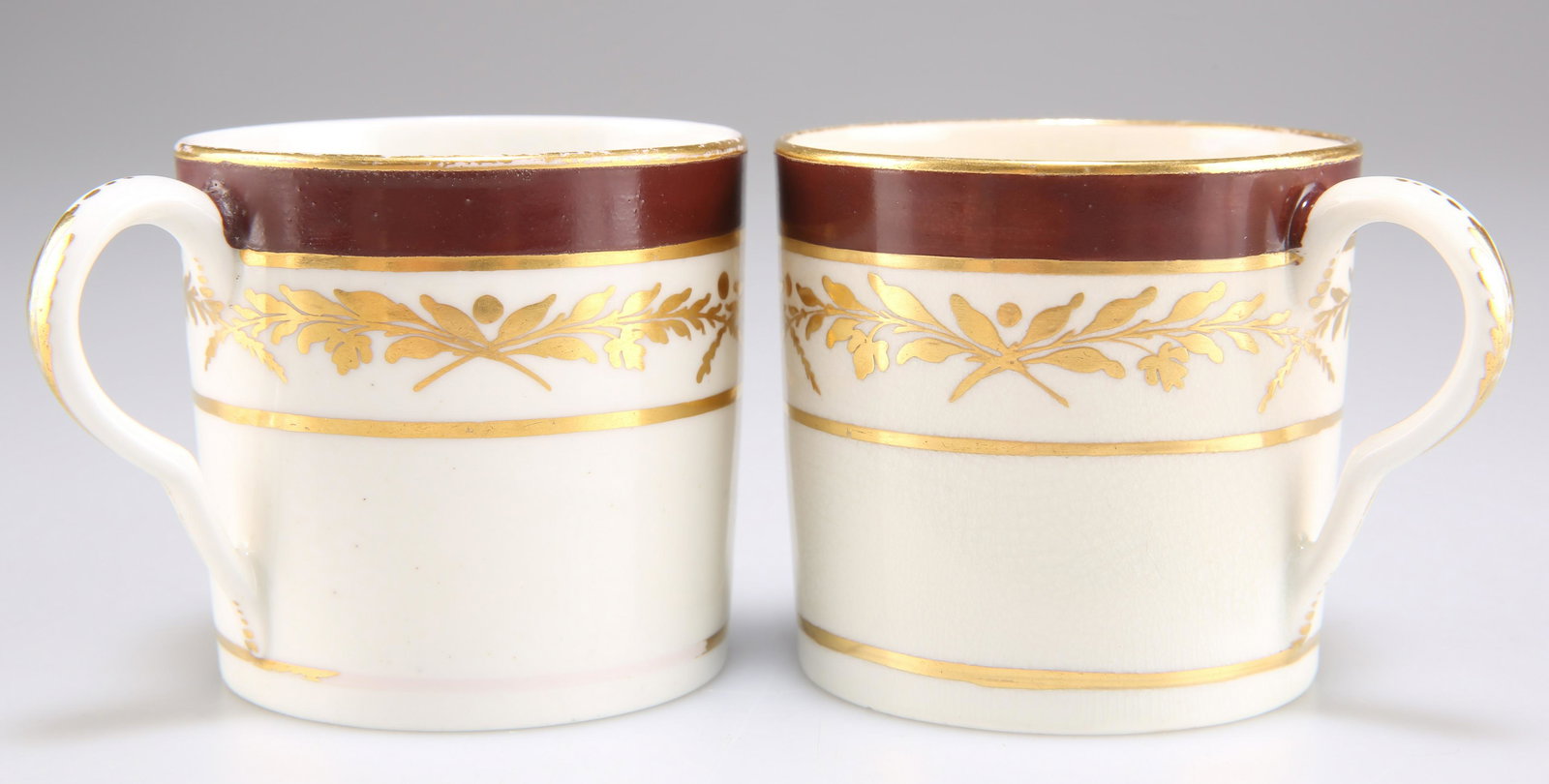 TWO PINXTON COFFEE CANS, each decorated with gilded foliage and ox-blood borders, one with pattern n (1 of 1)