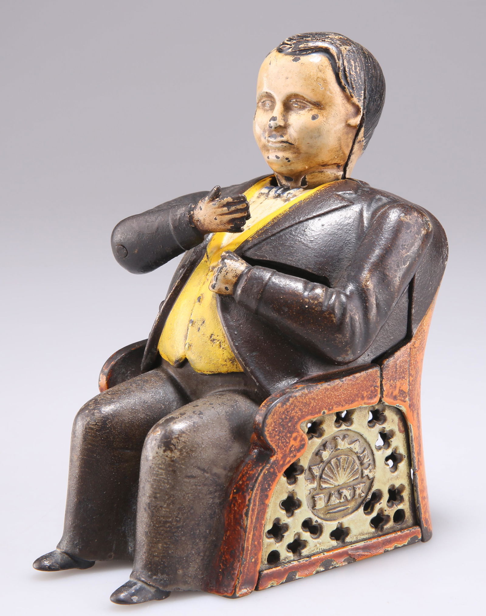A 19TH CENTURY AMERICAN NOVELTY CAST IRON TAMMANY BANK MONEY BOX, modelled as the seated figure of A: A 19TH CENTURY AMERICAN NOVELTY CAST IRON TAMMANY BANK MONEY BOX, modelled as the seated figure of American politician William Magear Tweed, dated June 8 1875. 14cm high