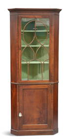 A GEORGE III MAHOGANY FLOOR-STANDING CORNER CABINET, the glazed door with moulded bars forming an at (1 of 1)