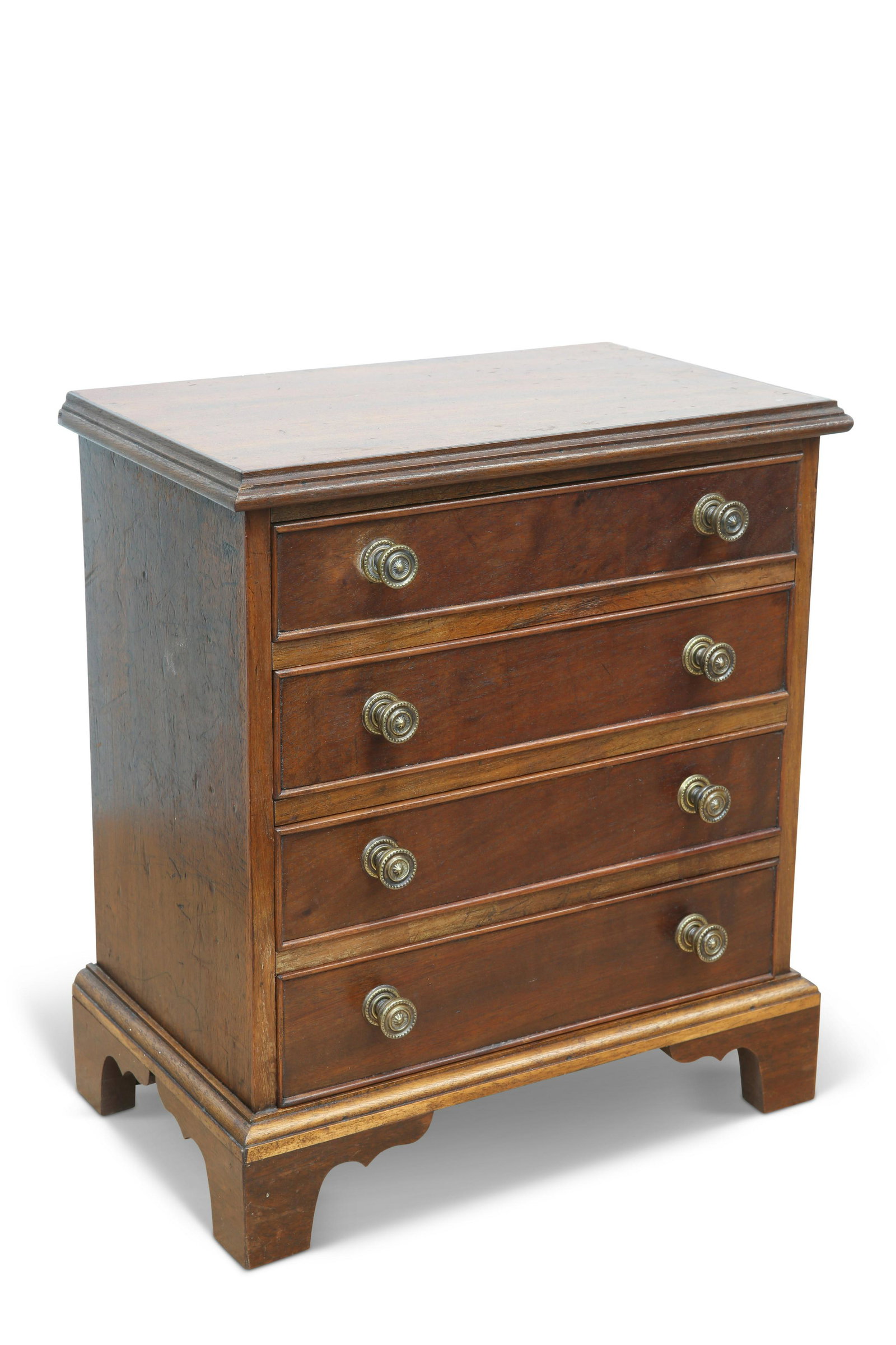 A GEORGE III STYLE MAHOGANY MINIATURE CHEST OF DRAWERS, the moulded rectangular top above four long (1 of 1)