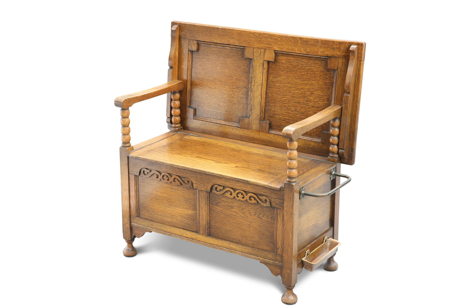 A 1920S OAK MONKâ€™S BENCH, with scroll-carved rail to the hinged box seat, raised on bun feet. 93cm (1 of 2)