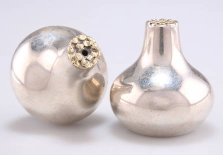 A PAIR OF ELIZABETH II SILVER AND PARCEL-GILT SALT AND PEPPER POTS: A PAIR OF ELIZABETH II SILVER AND PARCEL-GILT SALT AND PEPPER POTS, by Stuart Devlin, London 1976, each with textured top to the squat body. (2) 4.5cm high, 2.7 troy ounces gross