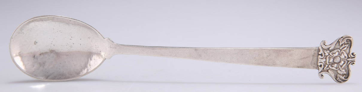 AN ARTS AND CRAFTS SILVER SPOON: AN ARTS AND CRAFTS SILVER SPOON, by Omar Ramsden & Alwyn Carr, London 1911, the terminal cast with a Tudor rose, the bowl spot-hammered. 20cm long, 1.7 troy ounces