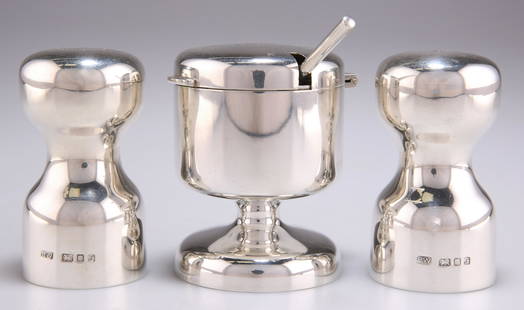 AN ELIZABETH II SILVER CONDIMENT SET: AN ELIZABETH II SILVER CONDIMENT SET, by Robert Welch, London 1973, plain dumbbell form, the mustard pot with a hinged cover and clear glass liner, with a mustard spoon. (4) Mustard 8.2cm high