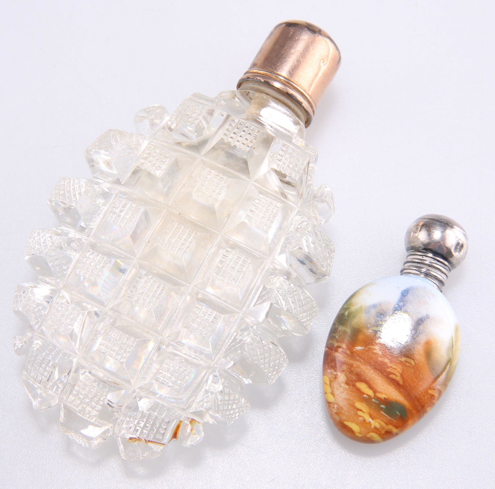 A VICTORIAN CUT-GLASS SCENT FLASK AND A SILVER-TOPPED PORCELAIN SCENT FLASK (1 of 1)