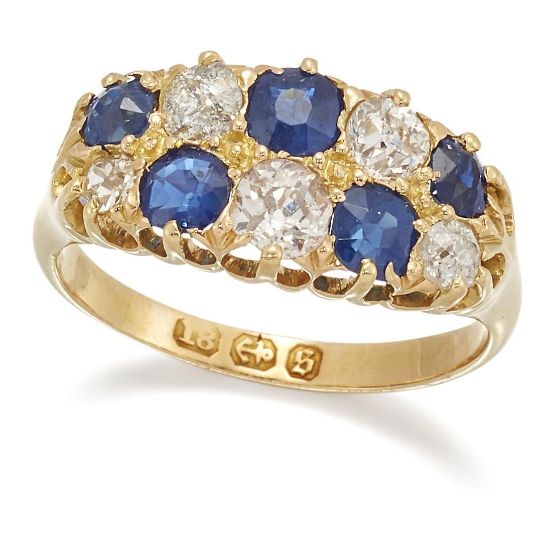 A VICTORIAN 18 CARAT GOLD SAPPHIRE AND DIAMOND RING: A VICTORIAN 18 CARAT GOLD SAPPHIRE AND DIAMOND RING, two rows of alternating cushion-cut sapphires and old-cut diamonds in raised claw settings. Estimated total diamond weight 0.75ct, hallmarked Birmi